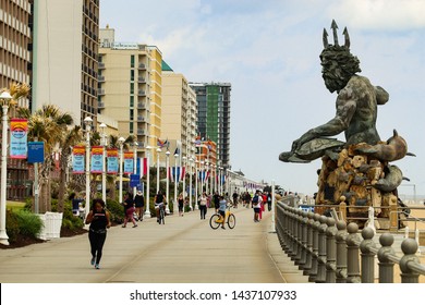 Virginia Beach, Virginia/United States - April 26, 2019: Recreational life along the Boardwalk of the Virginia Beach Oceanfront, featuring the King Neptune Statue.