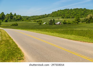 Virginia Farmland Along Highway Heading Into Appalachian Mountains And Blue Ridge Parkway. Farm With Family Cemetery On Hill In Background.