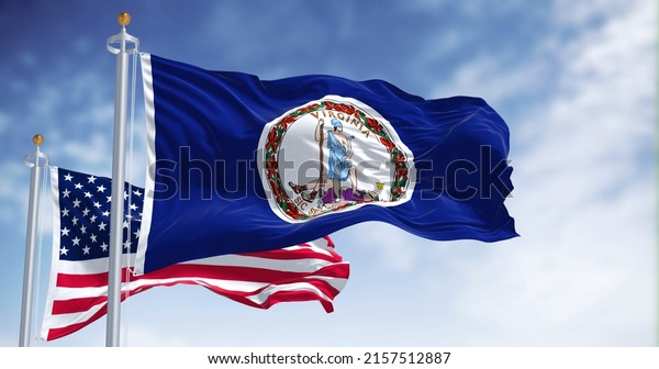 The
Virginia state flag waving along with the national flag of the
United States of America. Virginia is a state in the Mid-Atlantic
and Southeastern regions of the United
States