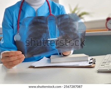 A virologist studies a chest X-ray with metapneumovirus. Causes acute respiratory viral infections in humans, mainly in children, and hMPV