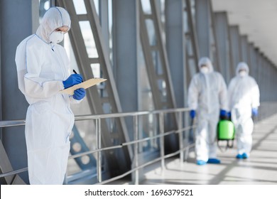Virologists in protective hazmat suits controlling epidemic, pathogen respiratory quarantine coronavirus concept, copy space - Shutterstock ID 1696379521