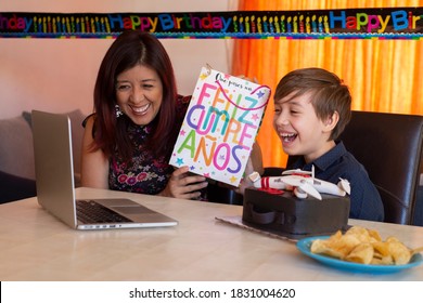 Virtual Birthday Due To The Pandemic, Family Celebrating His Birthday With A Drone Cake. Give A Gift With The Words Happy Birthday In Spanish