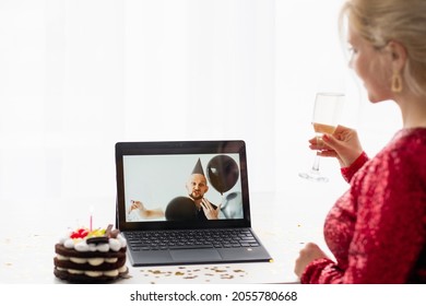 Virtual Birthday. Festive Greeting. Online Party. Unrecognizable Woman With Glass Champagne Holiday Cake Looking Congratulating Man On Laptop Isolated White.