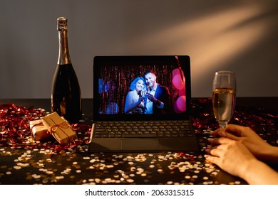 Virtual birthday. Festive greeting. Online party. Happy couple on tablet computer congratulating unrecognizable woman glass of champagne holiday confetti dark room interior. - Powered by Shutterstock