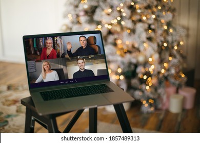 Virtual Christmas tree meeting team teleworking. Family video call remote conference. Laptop webcam screen view. Team meet working from their home offices. Happy hour party online woman team diversity - Powered by Shutterstock