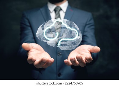 Virtual cloud and brain from the web. Man holding in his hand
