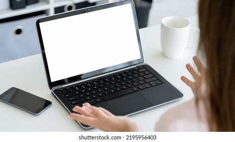 Virtual Conference. Female Speaker. Digital Mockup. Unrecognizable Woman Talking To Laptop With Blank Screen Gesturing Hands In Light Room Interior.