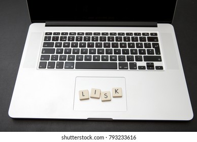 Virtual currency called Lisk written with letters on a modern laptop. Cryptocurrency concept image.