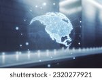 Virtual digital map of North America on blurry modern office building background, international trading concept. Multiexposure