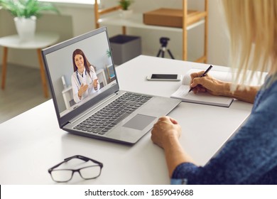 Virtual Doctor Appointment, Telemedicine Visit. Senior Woman Getting Online Medical Consultation. Mature Patient Having EHealth Video Call, Listening To Physician And Taking Notes, Writing Down Advice