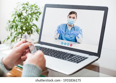 Virtual Doctor Visit,telemedicine Healthcare Concept,young Female Doctor Giving Advice Over Laptop Computer Screen To Elderly Woman,hands Holding Glasses Medical Worker On Display,remote Appointment