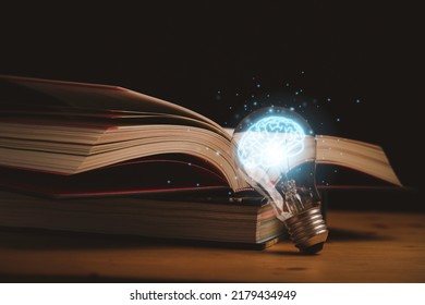 Virtual drawing of glowing blue brain with open book for knowledge study and education can make creative thinking idea concept. - Shutterstock ID 2179434949
