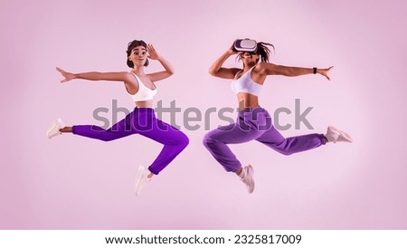 Virtual fitness game. Young black woman working out with 3D technology, jumping mid air as metaverse avatar wearing vr headset, purple studio background, full length