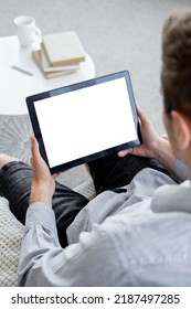 Virtual Life. Casual Man. Computer Mockup. Relaxed Unrecognizable Guy Sitting Home With Tablet Computer With Blank Screen In Light Room Interior.