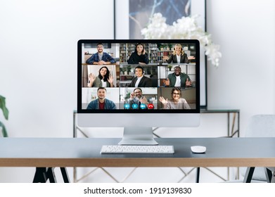 Virtual Meeting, Online Briefing, Brainstorm. A Computer Stands On The Desktop, On The Computer Screen Is Many Different Multiracial Business Partners, Gathered And Communication In A Video Call