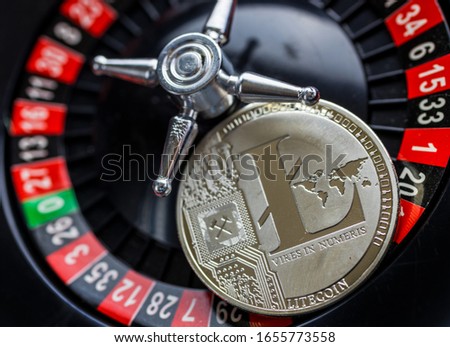 virtual money Litecoin LTC cryptocurrency - risky invenstment with the Litecoins currency - gold coin with a roulette as a symbol of risk