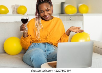 Virtual Party. African American Woman Having Video Conference With Friends And Family, Holding Glass Of Wine And Celebrating Birthday, Staying At Home