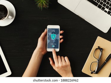 Virtual Private Network. Above top overhead view of woman holding and using smartphone with app vpn creation Internet protocols for protection, touching screen. Information and location security