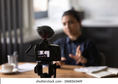 Virtual Public Speaking. Mixed Race Lady Teacher Trainer Shooting Video Lecture At Home Office Using Digital Camera Fixed On Holder. Young Indian Female Vlogger Influencer Recording Filming Content