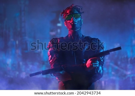 Virtual reality, city of the future. A tech cyber warrior fights with automatic guns in his hands against the backdrop of the night city.