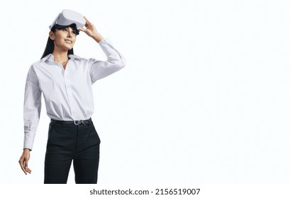 Virtual reality concept with standing young woman looking up and VR headset on her head isolated on white background with place for your logo or text, mockup - Powered by Shutterstock