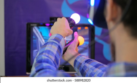 Virtual Reality Game. Young Man Using Virtual Reality Glasses And Hand Controlers