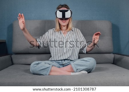 Virtual reality. The girl studies the game on the phono with glasses VR.  metaverse, digital world, immersive project. The virtual world VR , interactive at home.Metaverse home,Immersive experience