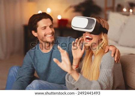 Virtual Reality. Happy Spouses Using VR Goggles Playing Videogame Sitting On Floor At Home. Selective Focus