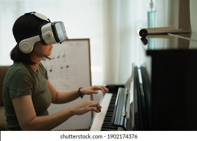 Virtual reality online class piano lesson from home, VR musical online learning conceptual. Piano teacher instructing student from VR technology.