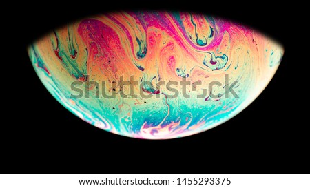Virtual reality space with abstract multicolor psychedelic planet. Closeup Soap bubble  like an alien planet on black background