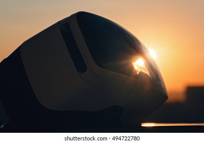 Virtual reality VR glasses silhouette sunlit by an amazing sunrise with a beautiful flare and soft focus with an superb morning orange sun - Powered by Shutterstock