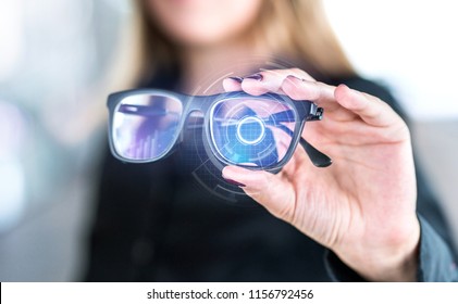 Virtual Screen Smart Glasses With Futuristic High Tech Interface. Woman Holding Spectacles With Nanotech Interface. Augmented Reality Vision With Modern Eyewear. Future Innovation With IOT And VR.