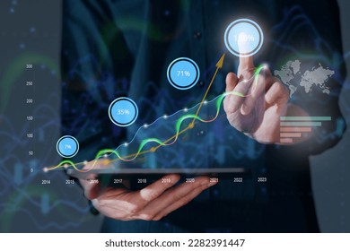 Virtual tablet PC screen with chart graph and businessman hand touch on new business finance strategy growth concept