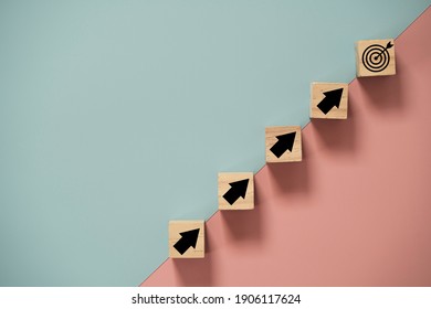 Virtual target board and arrow which print screen to wooden cube block on blue and pink background. Business achievement goal and objective target concept. - Shutterstock ID 1906117624