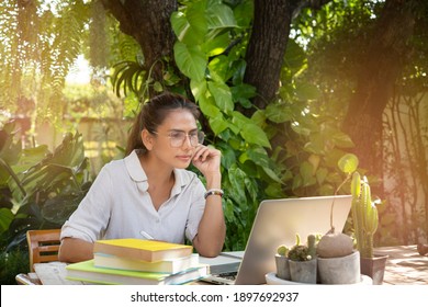 Virtual Teaching At Home Concept. Female Young College Tutor Coach Looking At Webcam And Talking In Classroom Giving Remote Class Online Lesson By Zoom Conference Call On Laptop.