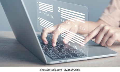 Virtual test or questionnaire show on screen and answer check mark to measure grades. Education futuristic technology. Students taking online exams by laptop and Lifelong learning concept.