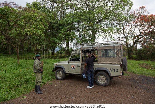 Virunga\
National Park, DR CONGO - October 5th 2015 - A safari driver in a\
safari car being escorted by a fully equipped ranger inside the\
Virunga National Park in DRC, Central\
Africa.