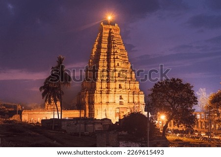 Virupaksha Temple and its surroundings as seen in the evening with a magical twilight sky as a backdrop in Hampi, Karnataka, India