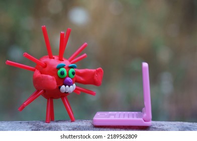 A Virus Figurine With A Laptop. Business, Finance And Information Technology.