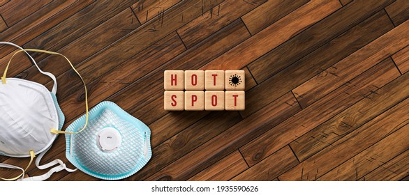 Virus Hot Spot Concept For The Covid-19 Or Coronavirus Pandemic With Text And Virus Icon On Wooden Cubes Alongside Protective Face Masks On A Diagonal Wooden Background