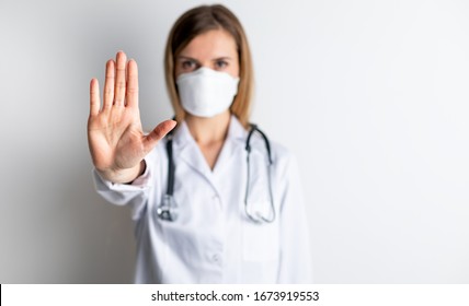 Virus mask female doctor wearing face protection in prevention for coronavirus showing gesture Stop Infection