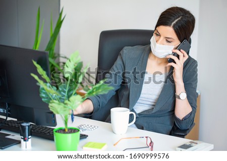 Virus.Woman at the office sick with mask for corona virus. Business women wear masks to protect and take care of their health. Home working with computer. Working from home.
