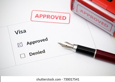 Visa and approved stamp on a document form. Immigration and travel concept - Shutterstock ID 730017541