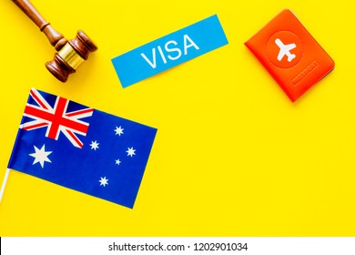 Visa To Australia Concept. Text Visa Near Passport Cover And Australian Flag, Hammer On Yellow Background Top View Copy Space