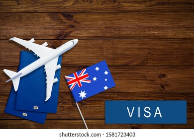 Visa To Australia Concept. Text Visa Near Passport Cover And Australian Flag, Hammer On Dark Wooden Background Top View Copy Space