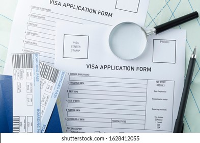 Visa Center Paperwork.Blank Form For Getting Visa To Travel, Entry Foreign Countries.Top View Of Application Form For Visa, Passports, Tickets, Pen, Magnifying Glass On The Map