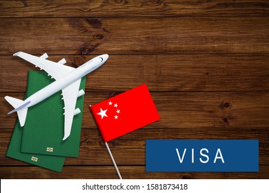 Visa To China Concept. Chinese Flag Near Passport On Dark Wooden Background Top-down Copy Space