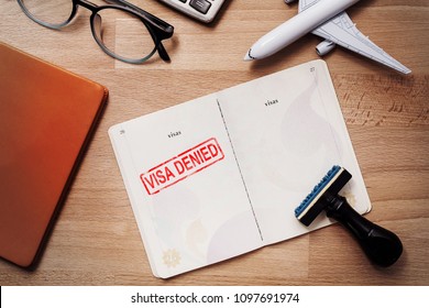 visa and passport with denied stamp on a document top view in immigration. travel immigration stamp and tourism concept - Shutterstock ID 1097691974