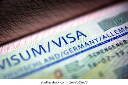 Visa stamp in passport close-up. German visitor visa at border control. Document for multiple entry. Macro view of Schengen visa for tourism and travel in EU. Legal immigration to Germany and Europe. - Shutterstock ID 1647865678