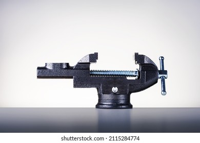 Vise tool on a workbench. Concept hand tools, pressure.